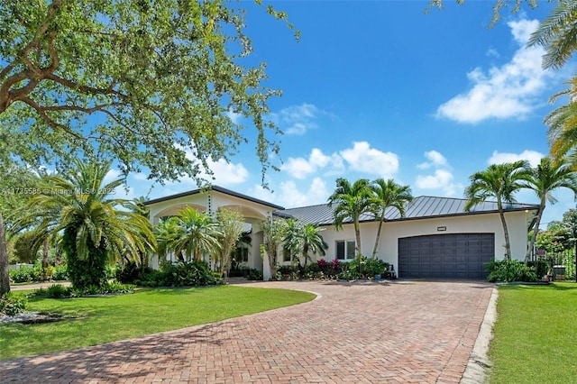 ranch-style home featuring a garage and a front yard