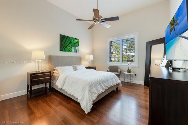 bedroom with ceiling fan, lofted ceiling, and dark hardwood / wood-style flooring