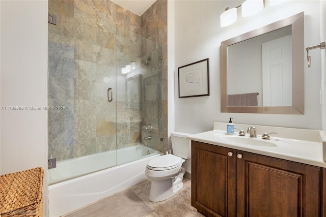 full bathroom featuring tile patterned flooring, enclosed tub / shower combo, vanity, and toilet