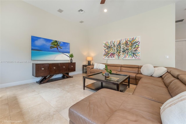 tiled living room featuring a towering ceiling and ceiling fan