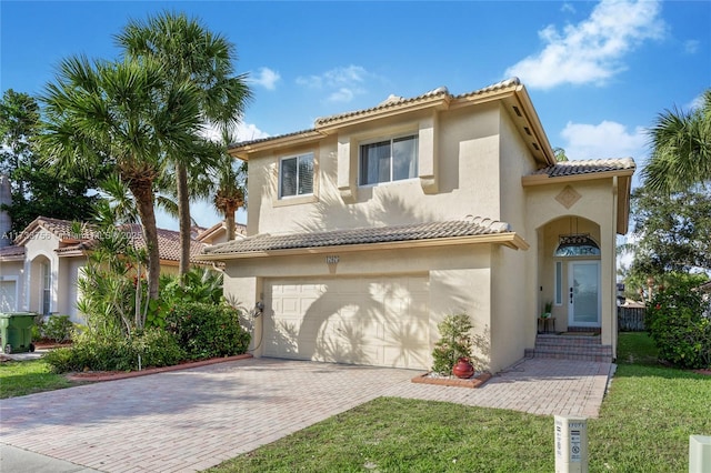 mediterranean / spanish-style home with a garage and a front yard