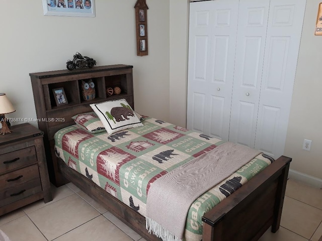 bedroom featuring light tile patterned floors and a closet