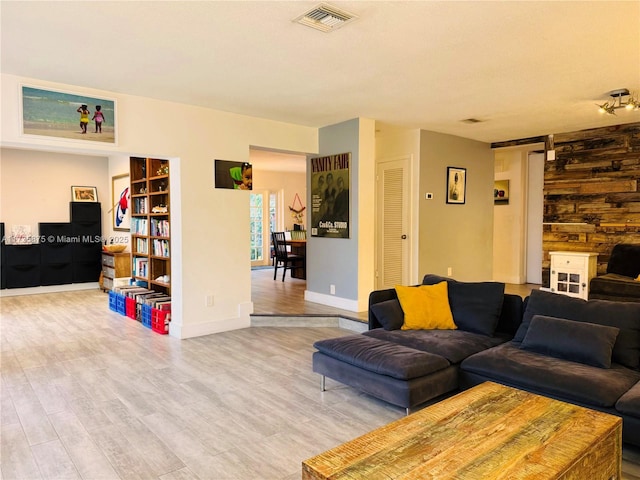 living room featuring wood-type flooring and a barn door