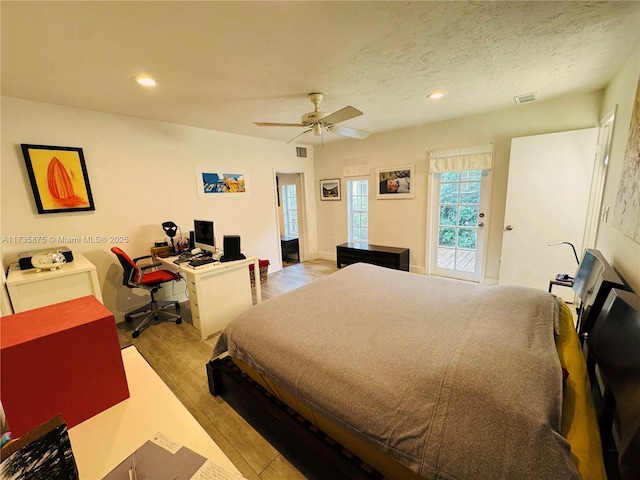 bedroom with ceiling fan, a textured ceiling, access to exterior, and light wood-type flooring