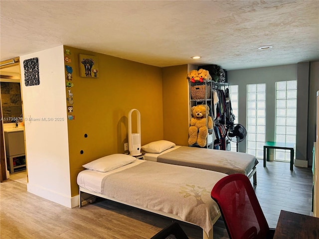 bedroom featuring a textured ceiling and light wood-type flooring