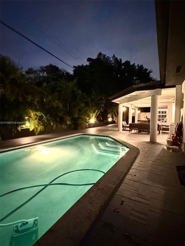 pool at night with a patio