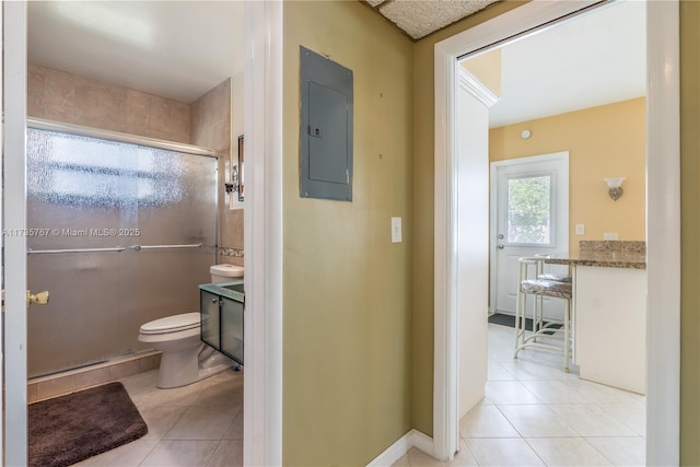 bathroom with tile patterned flooring, electric panel, vanity, an enclosed shower, and toilet