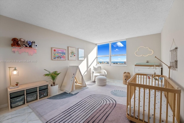 bedroom featuring a textured ceiling and a crib