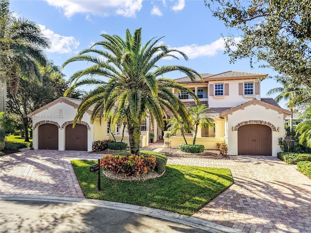 mediterranean / spanish home featuring a garage