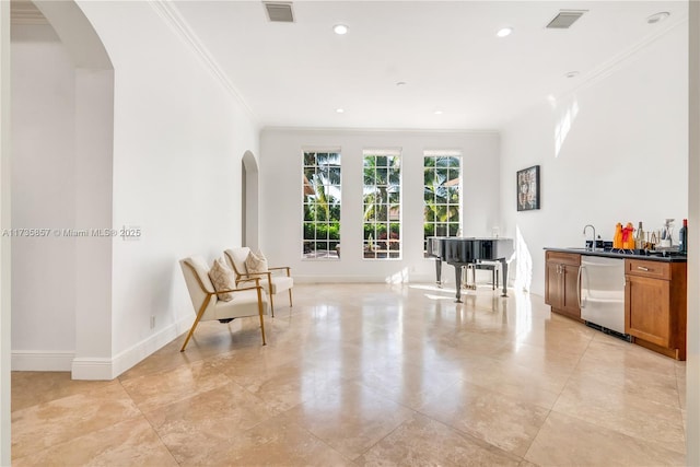 interior space featuring crown molding and bar