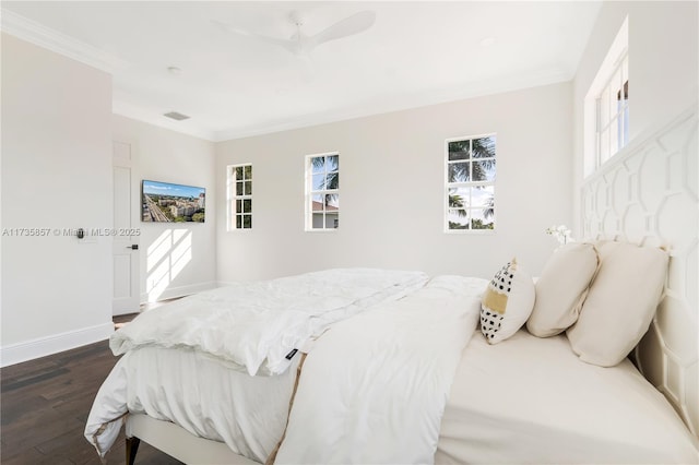 bedroom with ornamental molding, ceiling fan, and dark hardwood / wood-style flooring