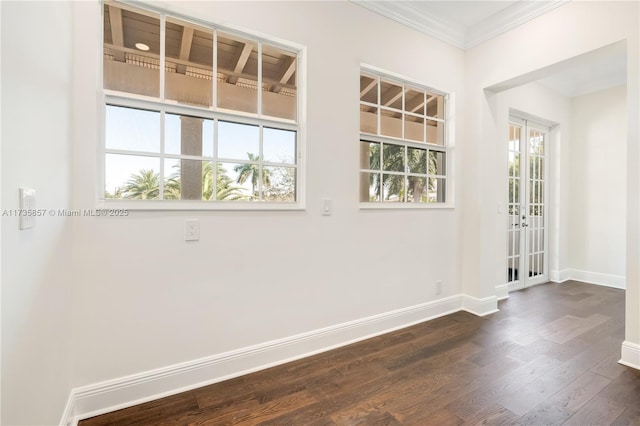 empty room with ornamental molding and dark wood-type flooring