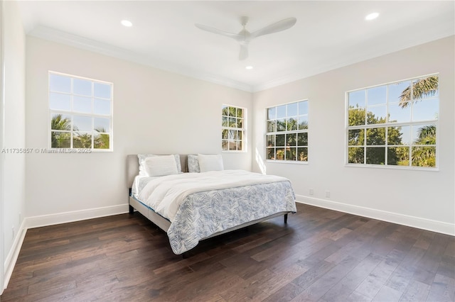 bedroom with ceiling fan, ornamental molding, and dark hardwood / wood-style flooring