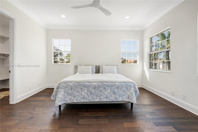 bedroom featuring ornamental molding, dark wood-type flooring, and ceiling fan