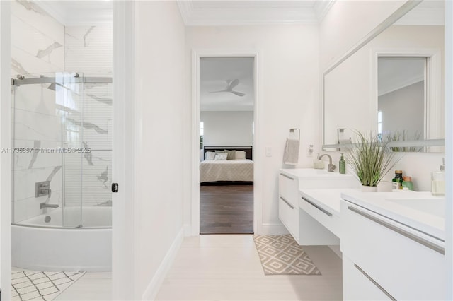 bathroom with crown molding, vanity, and bath / shower combo with glass door