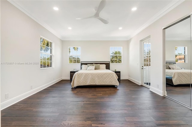 bedroom with crown molding, dark wood-type flooring, a closet, and ceiling fan