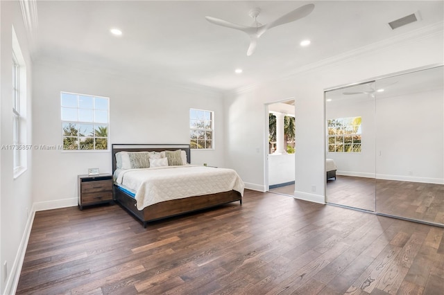 bedroom with ceiling fan, ornamental molding, and dark hardwood / wood-style floors