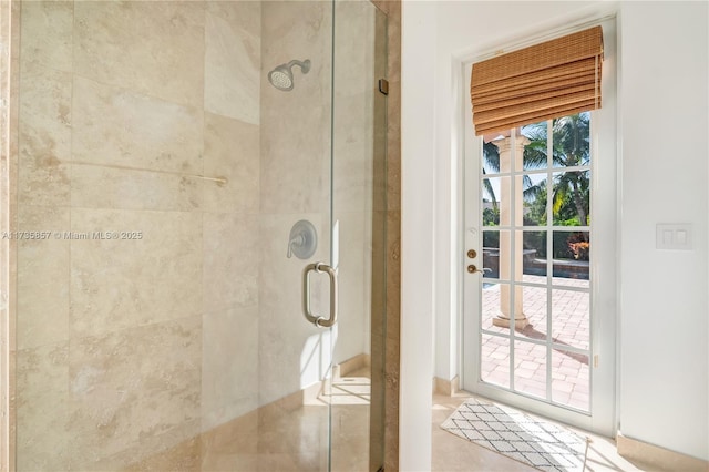 bathroom with an enclosed shower and a healthy amount of sunlight