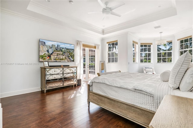 bedroom with a raised ceiling, access to outside, dark hardwood / wood-style flooring, and french doors