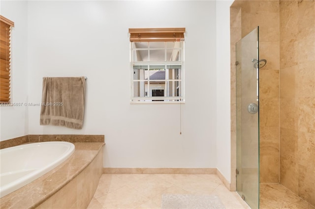 bathroom with tile patterned floors and independent shower and bath