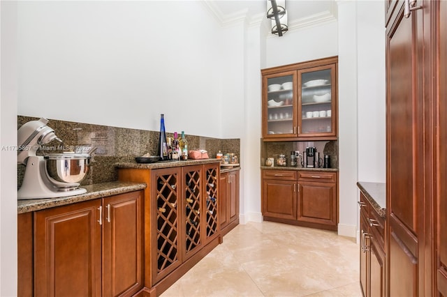 bar featuring crown molding, dark stone counters, and decorative backsplash