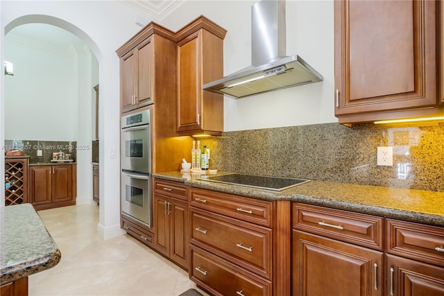 kitchen featuring stone counters, extractor fan, double oven, tasteful backsplash, and black electric cooktop