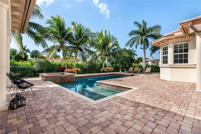 view of pool featuring an in ground hot tub and a patio