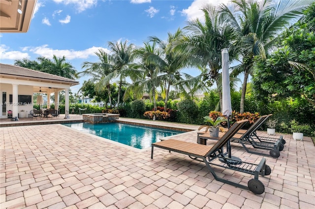 view of swimming pool with a patio area and an in ground hot tub