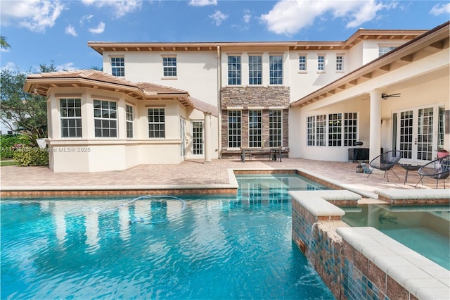 view of pool featuring an in ground hot tub, a patio area, and french doors