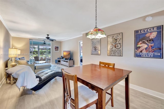 700 SE 6th Ave Unit 203, Deerfield Beach, FL 33441 - dining area featuring a ceiling fan, crown molding, light wood-style flooring, and baseboards