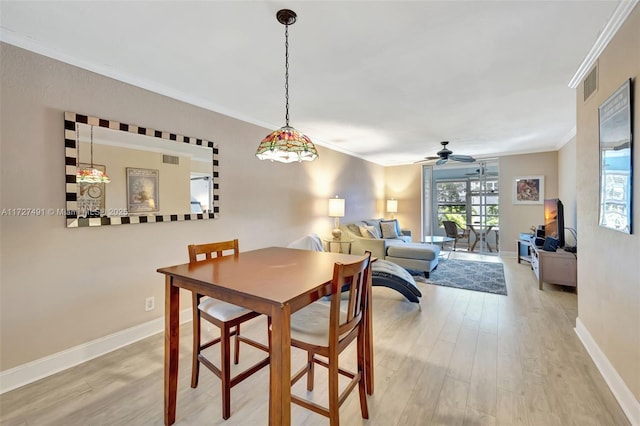 700 SE 6th Ave Unit 203, Deerfield Beach, FL 33441 - dining room featuring baseboards, ceiling fan, wood finished floors, and crown molding