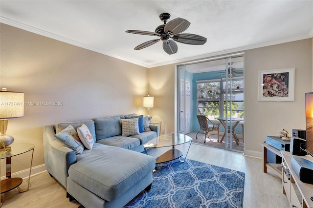 700 SE 6th Ave Unit 203, Deerfield Beach, FL 33441 - living room featuring light wood-type flooring, crown molding, baseboards, and ceiling fan