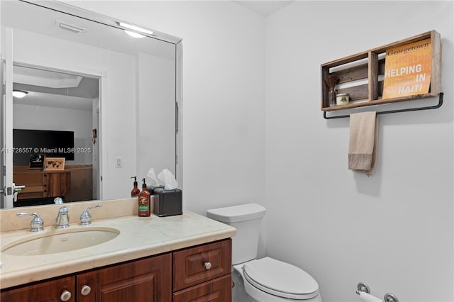 bathroom featuring vanity and toilet