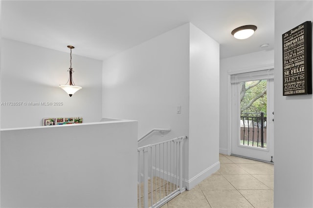 corridor featuring light tile patterned floors