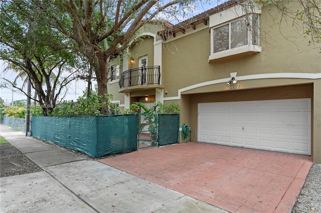 view of front of home with a balcony and a garage