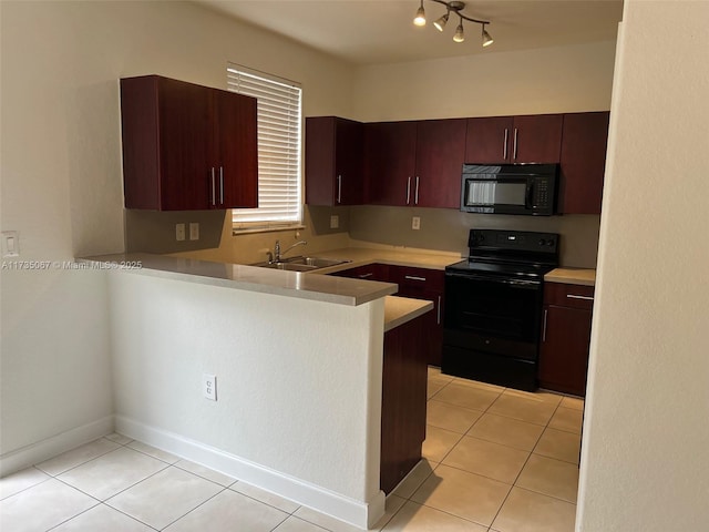 kitchen featuring light tile patterned floors, kitchen peninsula, sink, and black appliances