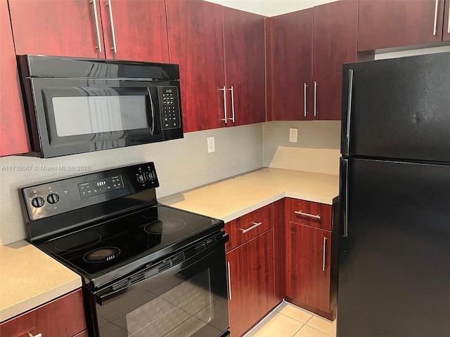 kitchen with black appliances and light tile patterned flooring