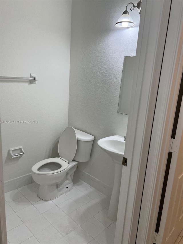 bathroom with sink, tile patterned floors, and toilet