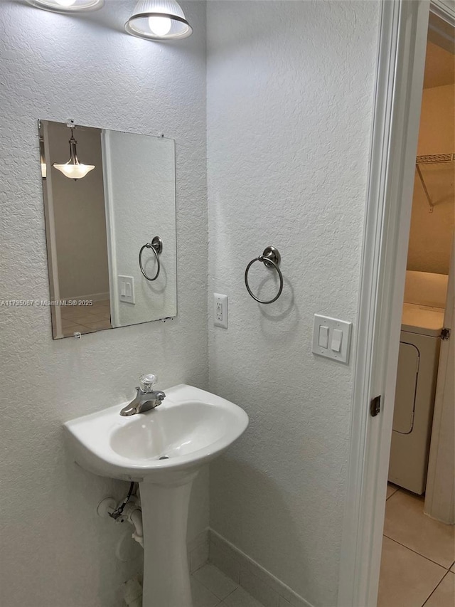 bathroom with tile patterned flooring and washer / clothes dryer