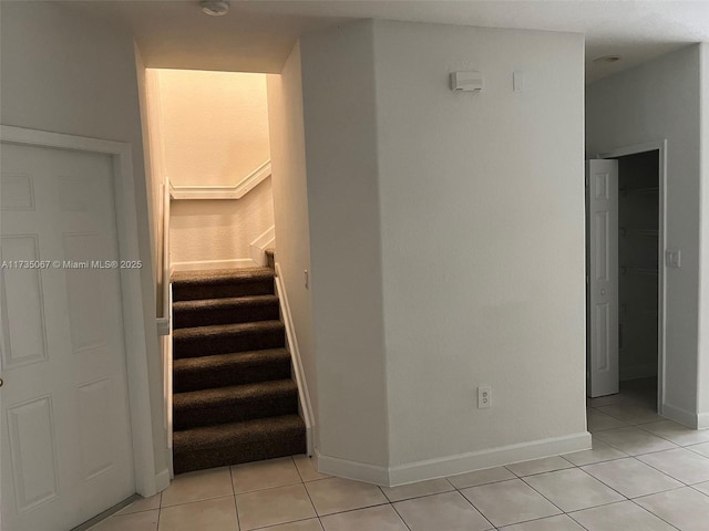 stairway featuring tile patterned floors