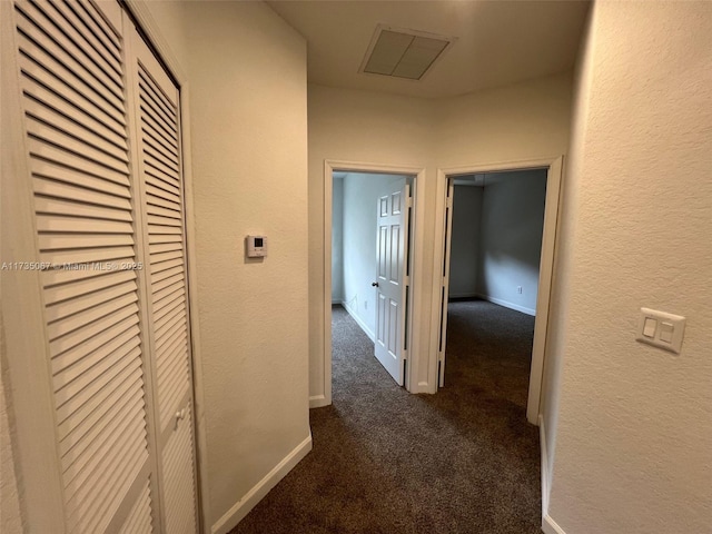 corridor with dark colored carpet