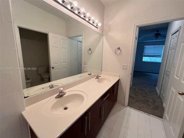 bathroom with vanity, toilet, and tile patterned flooring