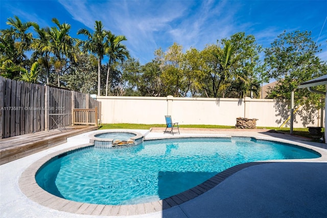 view of pool with an in ground hot tub