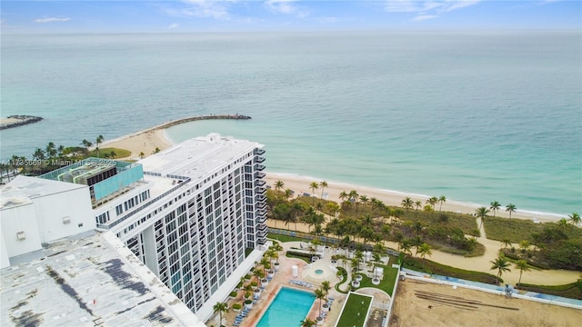 drone / aerial view with a water view and a beach view