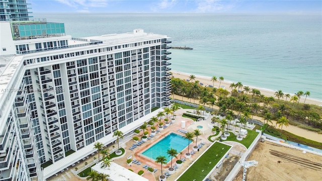 bird's eye view with a water view and a beach view