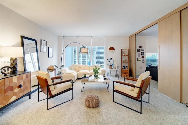 living room featuring light colored carpet and floor to ceiling windows