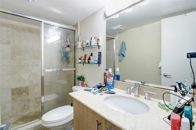 bathroom with vanity, toilet, and walk in shower