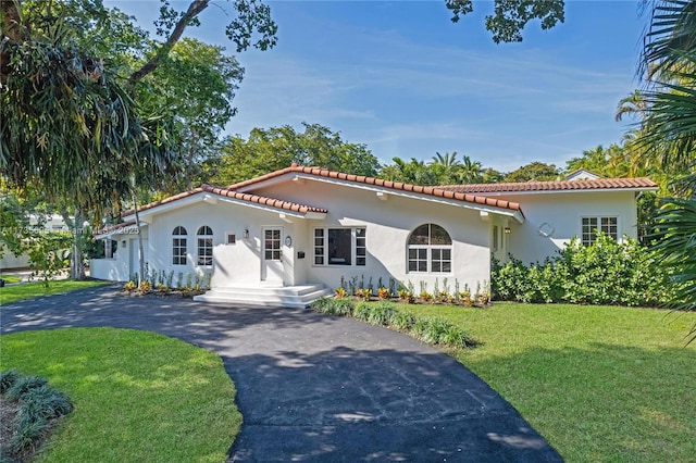 mediterranean / spanish-style house with a front yard