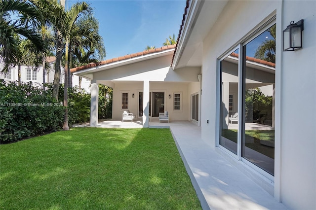 back of house with a yard and a patio area