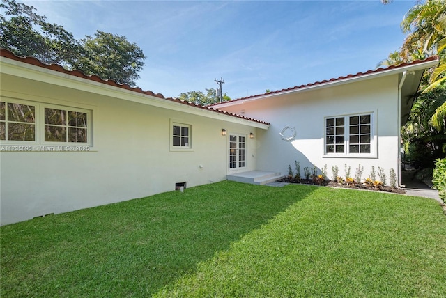 back of house with a lawn